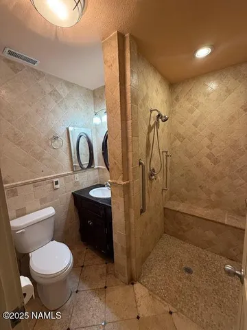 a bathroom with a toilet sink and shower