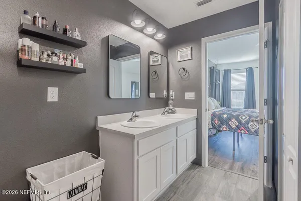 a bathroom with a sink a toilet and mirror