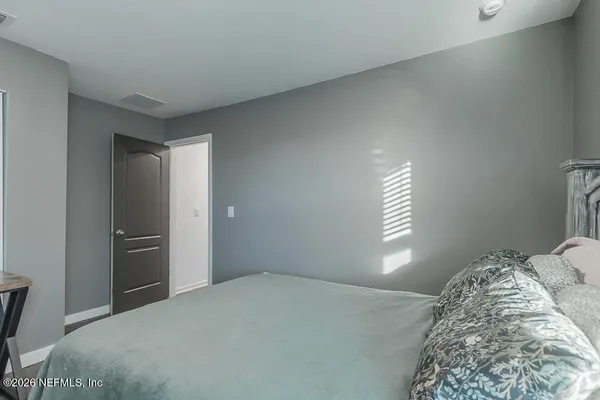 a bedroom with a bed and a window