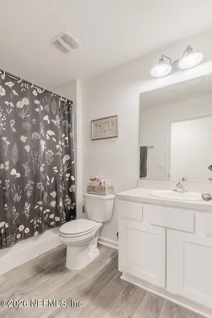a bathroom with a sink toilet and a mirror