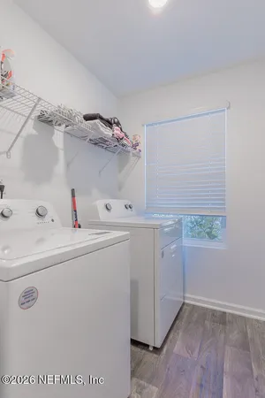 a utility room with cabinets washer and dryer