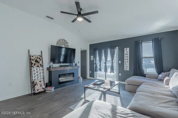 a living room with furniture fireplace and flat screen tv