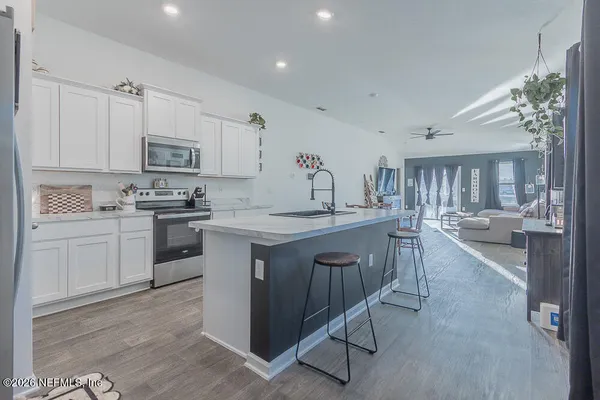 a kitchen with kitchen island granite countertop lots of counter top space and stainless steel appliances