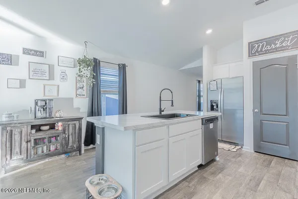 a kitchen that has a lot of cabinets in it and appliances