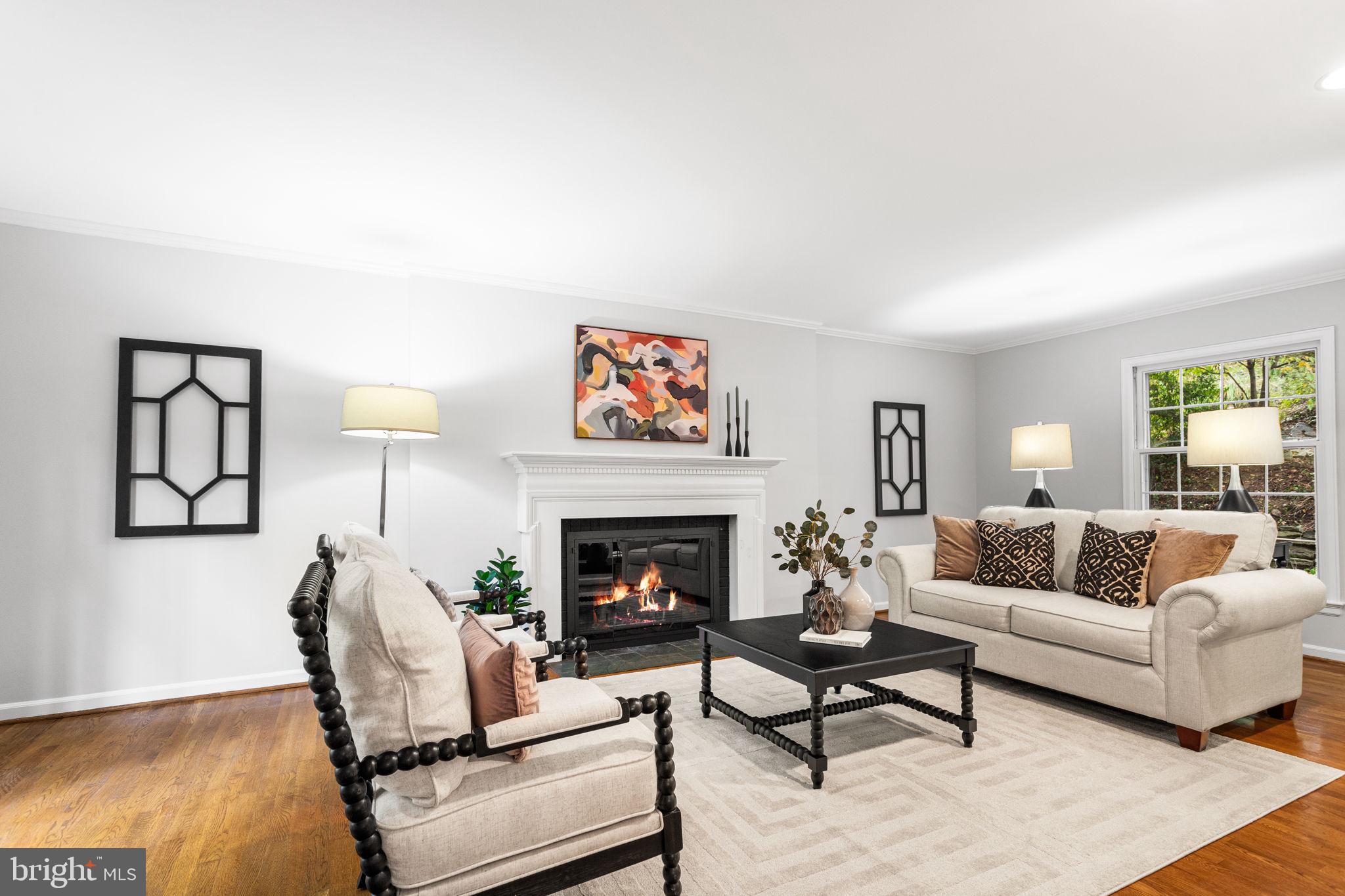 7404 Rippon Road Alexandria, VA 22307 - Photo 5 of 28 a living room with furniture dining table and a fireplace
