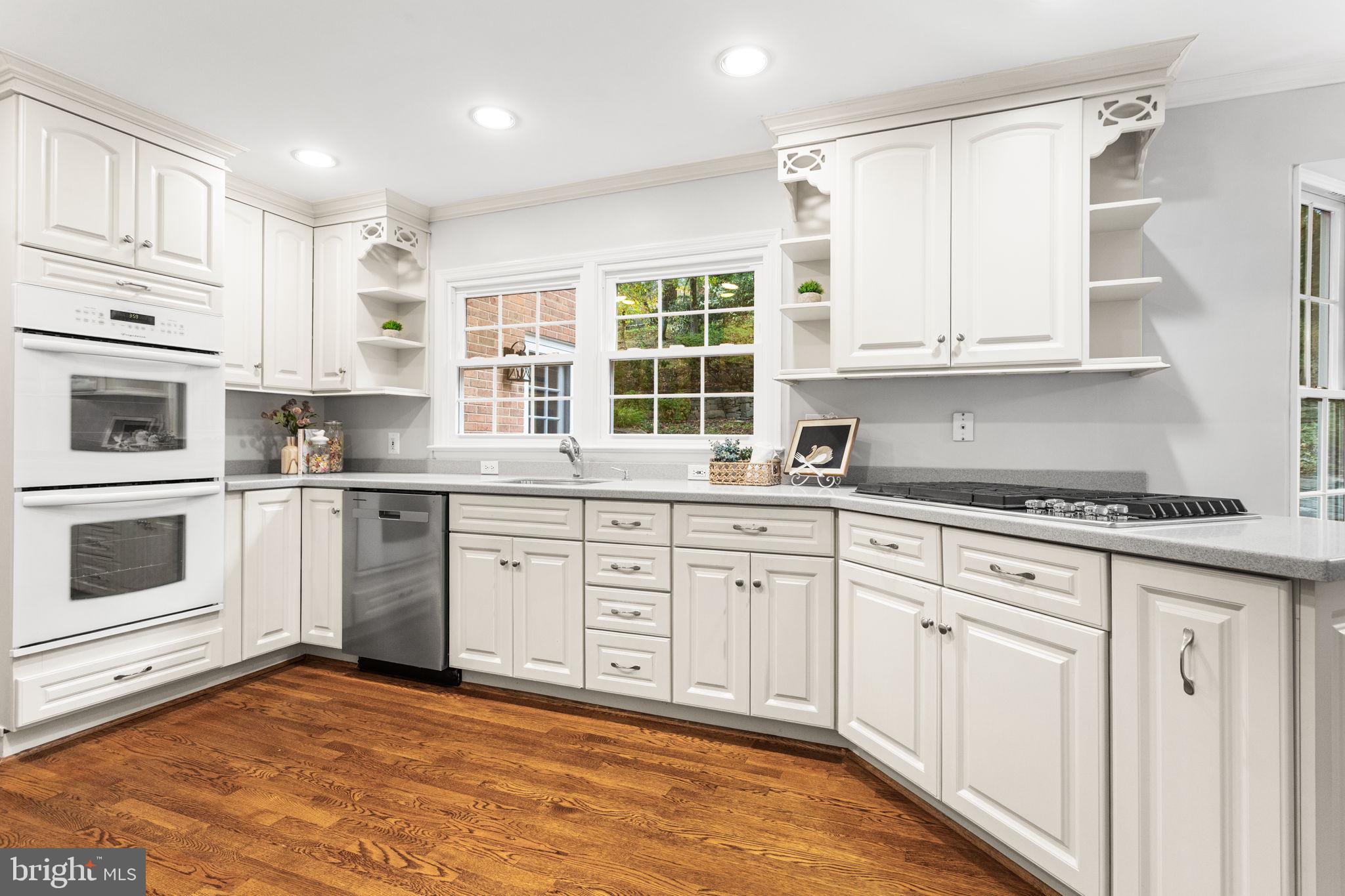 7404 Rippon Road Alexandria, VA 22307 - Photo 8 of 28 a kitchen with granite countertop white cabinets white stainless steel appliances with a sink and dishwasher
