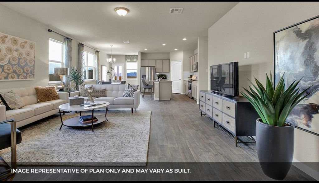 156 Docile Loop San Marcos, TX 78666 - Photo 30 of 40 An open-concept interior unites living, dining, and kitchen areas, bathed in natural light.