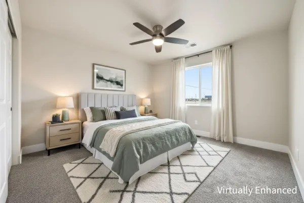 a bedroom with a bed couches and a chandelier
