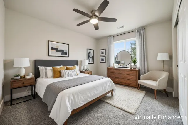 an empty room with a window and ceiling fan