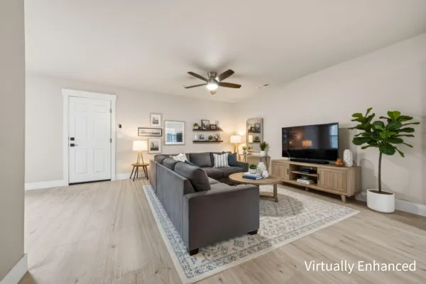 a view of a kitchen with refrigerator and white cabinets