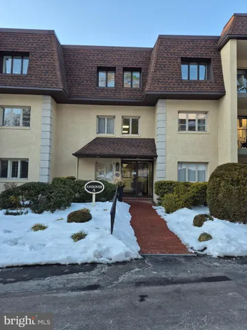 a front view of a house with yard and furniture
