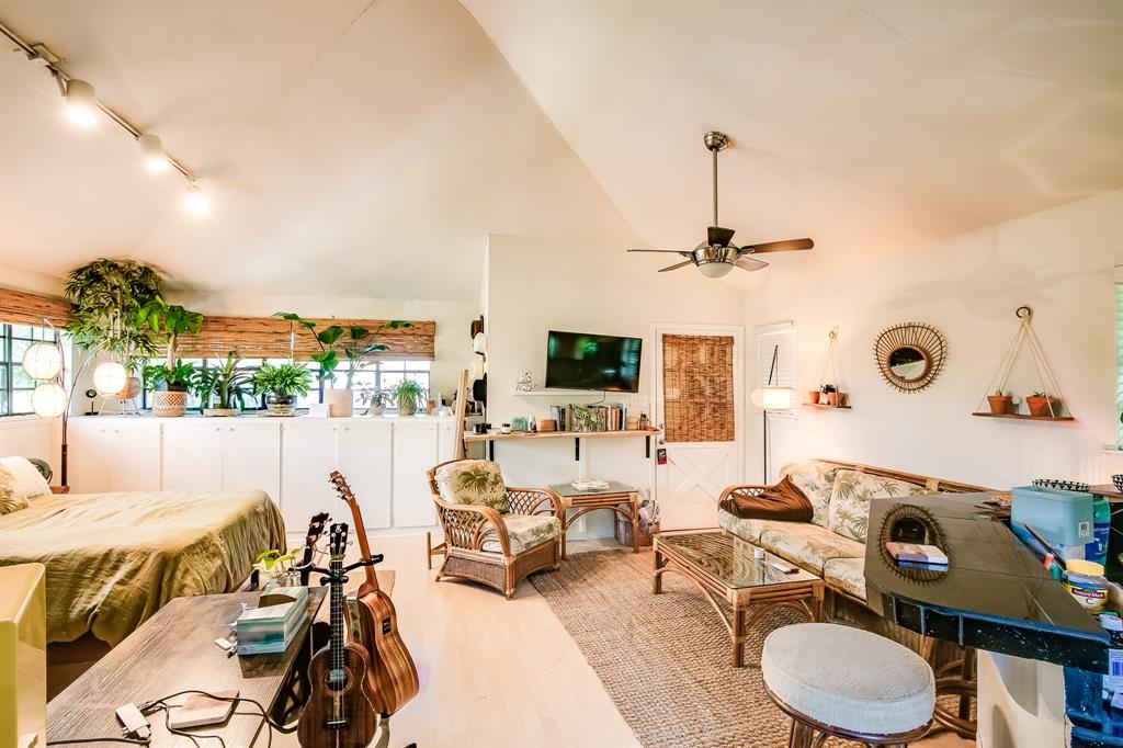 2400 Thornton Road, Unit A Austin, TX 78704 - Photo 2 of 13 Living area featuring track lighting, wood finished floors, a ceiling fan, and high vaulted ceiling