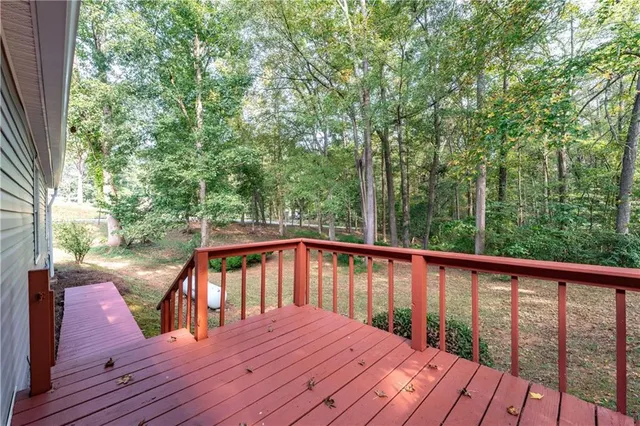 a balcony with wooden floor and outdoor space