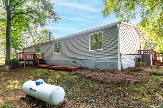 a backyard of a house with yard and outdoor seating
