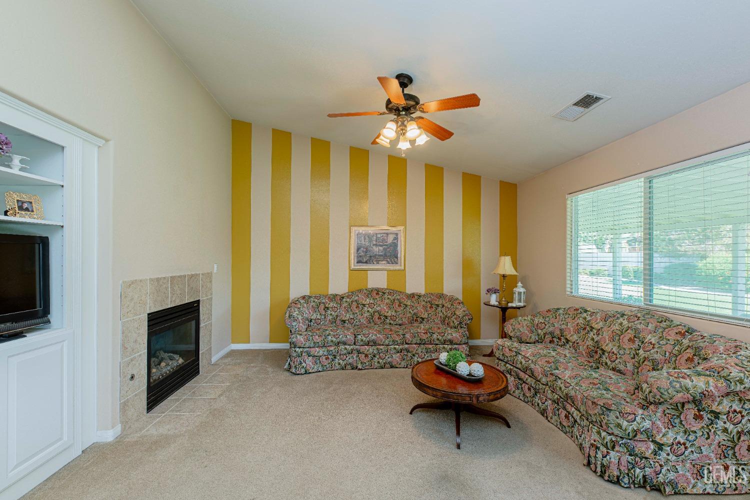 Undisclosed Address Bakersfield, CA 93312 - Photo 11 of 41 a living room with furniture and a fireplace