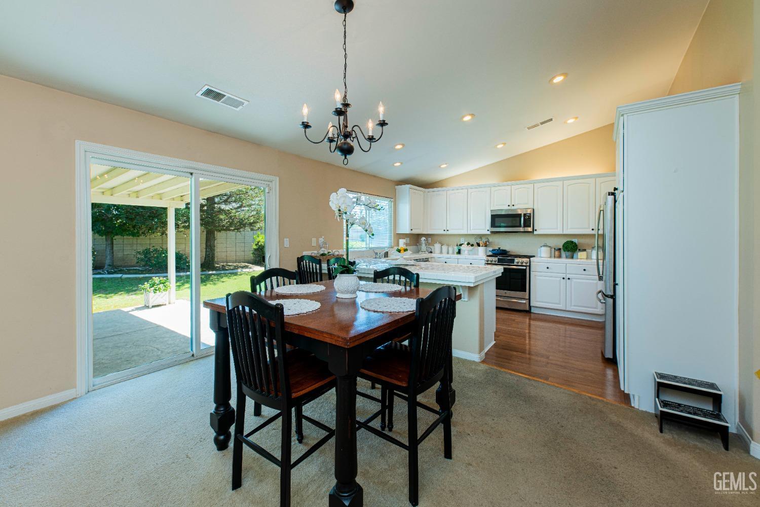 Undisclosed Address Bakersfield, CA 93312 - Photo 14 of 41 a large kitchen with a table and chairs