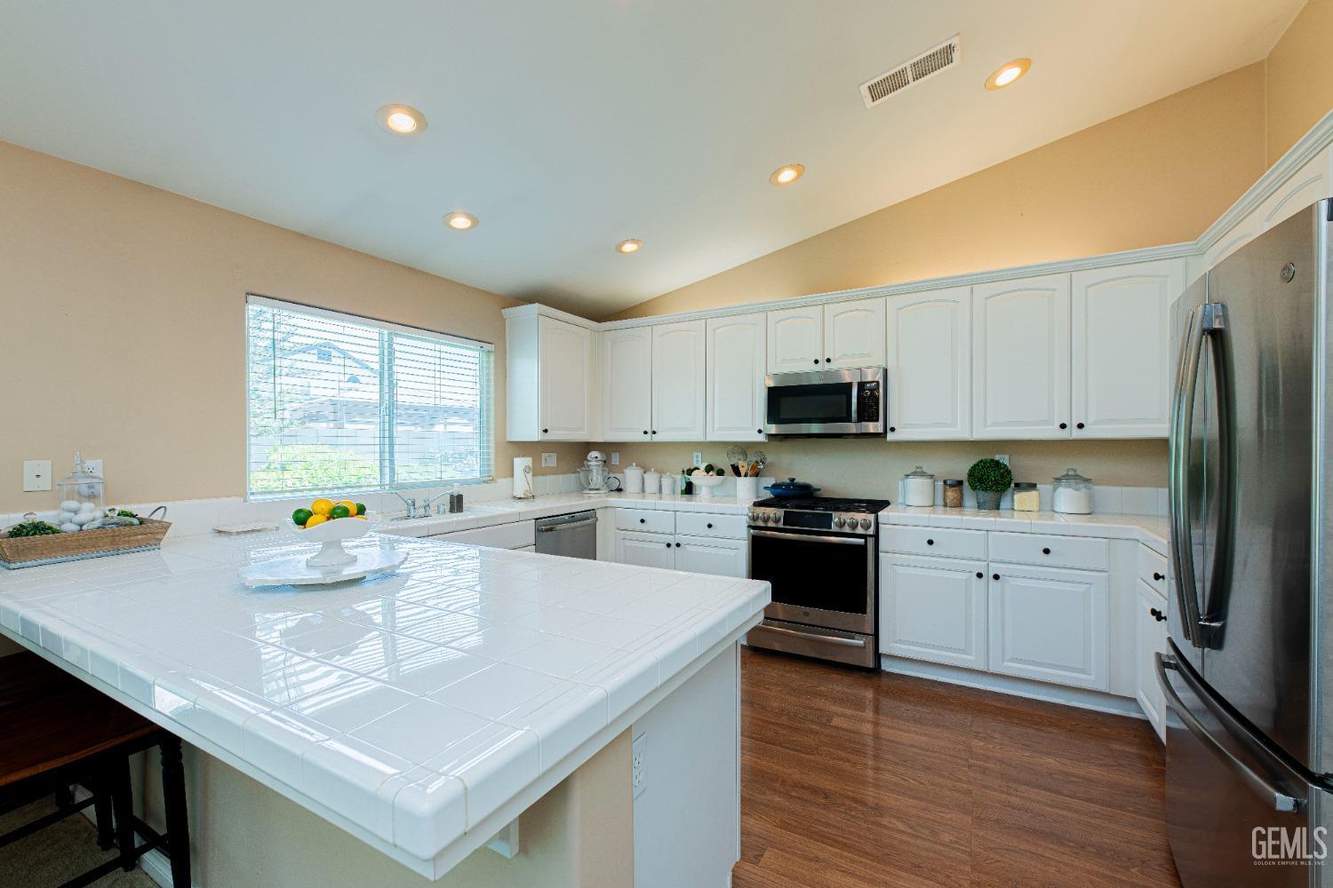 Undisclosed Address Bakersfield, CA 93312 - Photo 15 of 41 a kitchen with sink a stove and cabinets