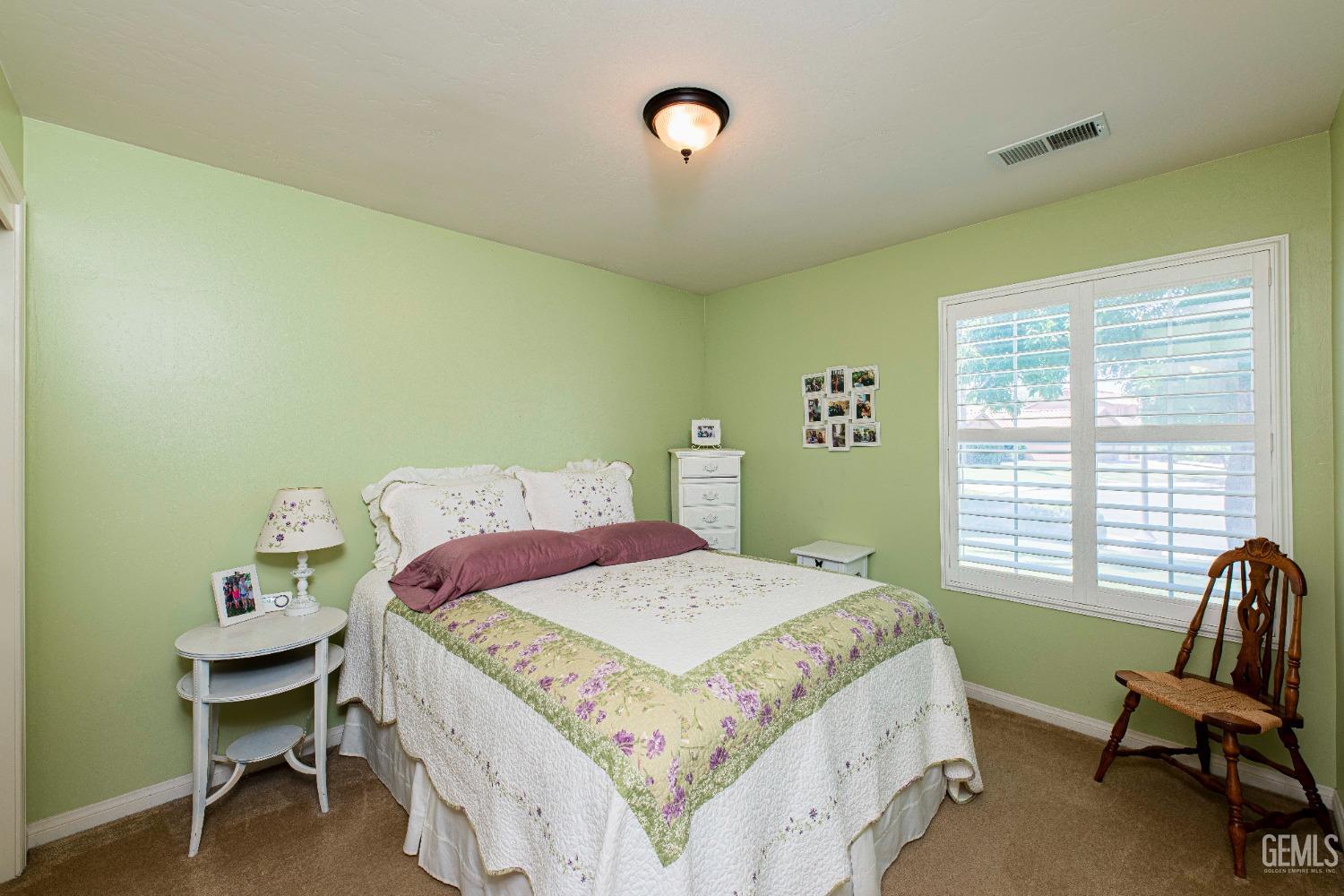 Undisclosed Address Bakersfield, CA 93312 - Photo 19 of 41 a bedroom with a bed chair and a window