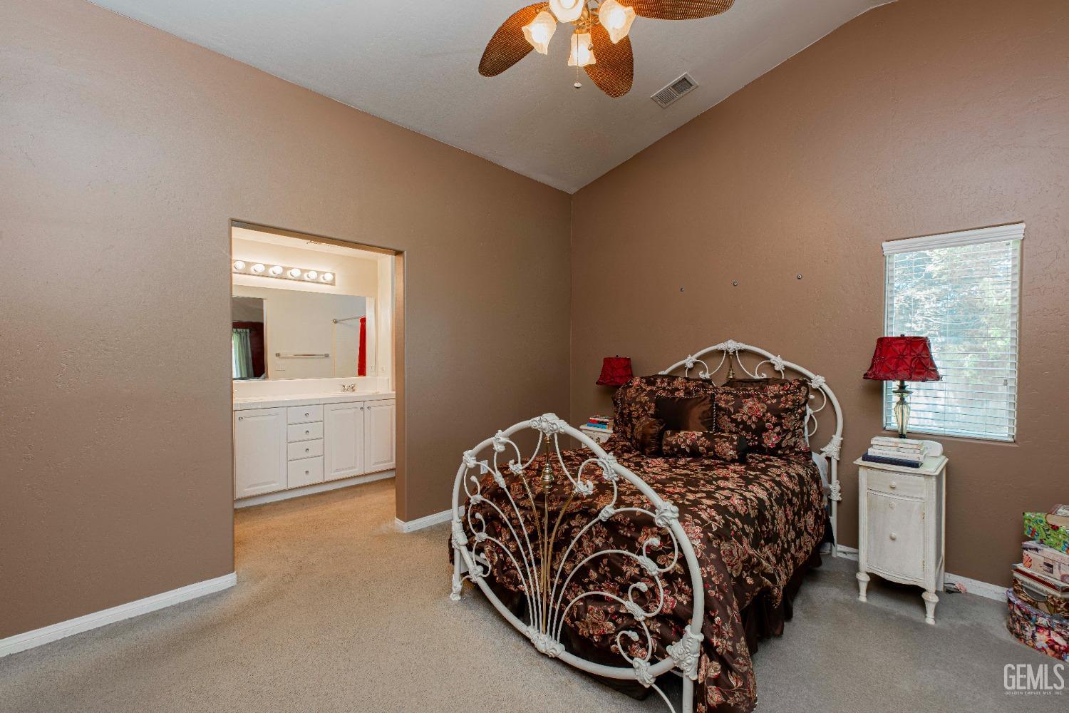 Undisclosed Address Bakersfield, CA 93312 - Photo 26 of 41 a bedroom with a bed and a chandelier