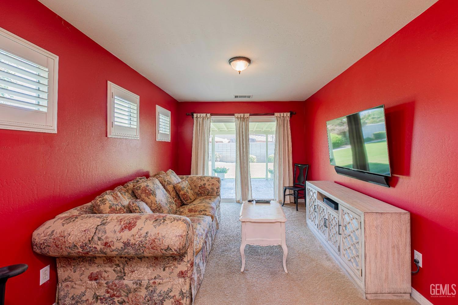 Undisclosed Address Bakersfield, CA 93312 - Photo 27 of 41 a living room with furniture and a floor to ceiling window