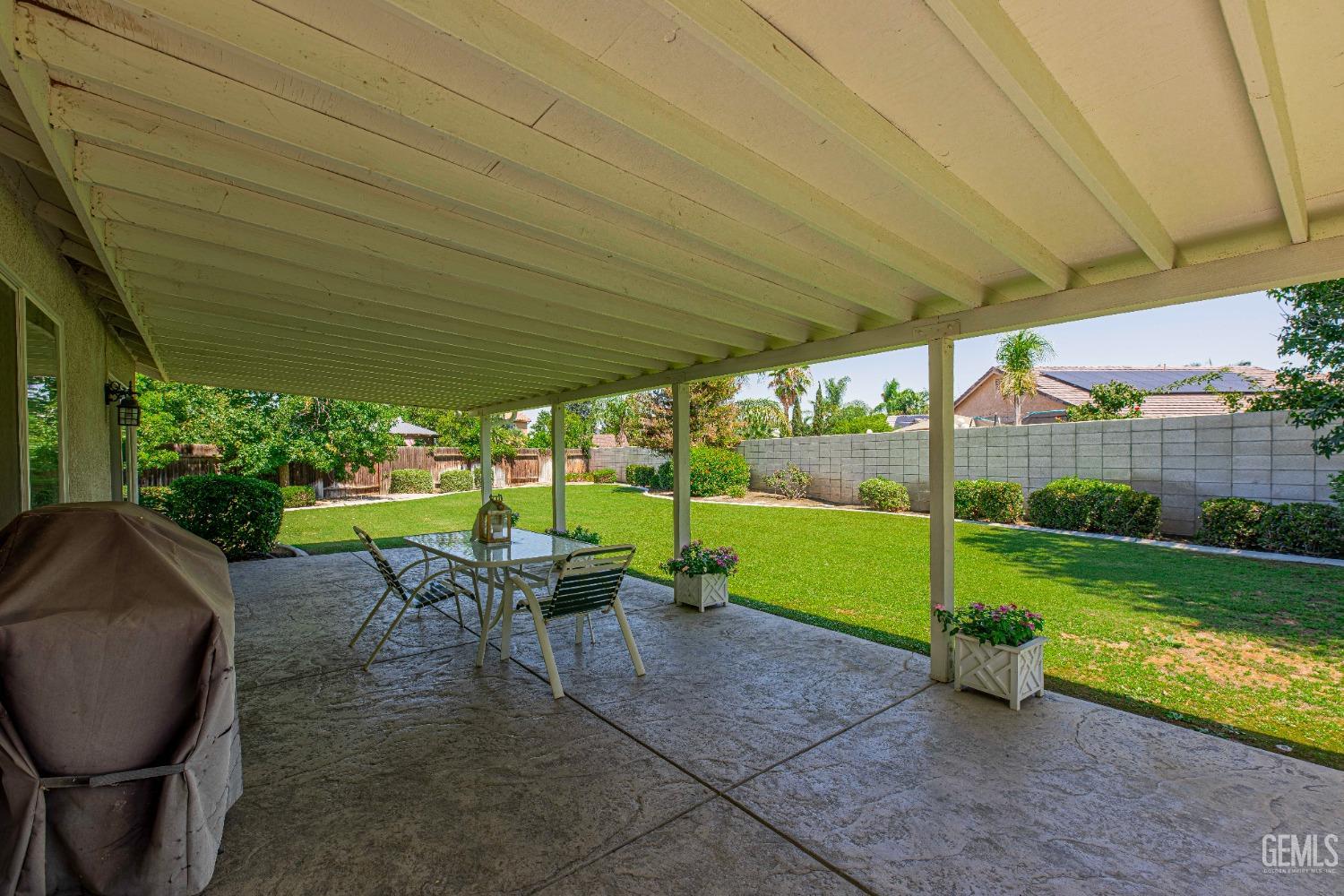 Undisclosed Address Bakersfield, CA 93312 - Photo 30 of 41 a view of pool with table and chairs under an umbrella