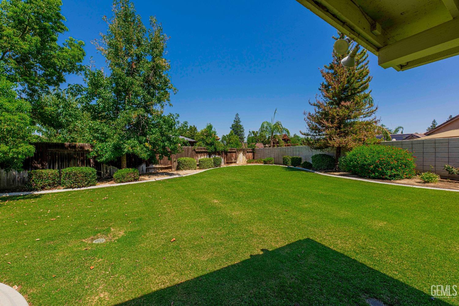 Undisclosed Address Bakersfield, CA 93312 - Photo 32 of 41 a view of yard with swimming pool and green space