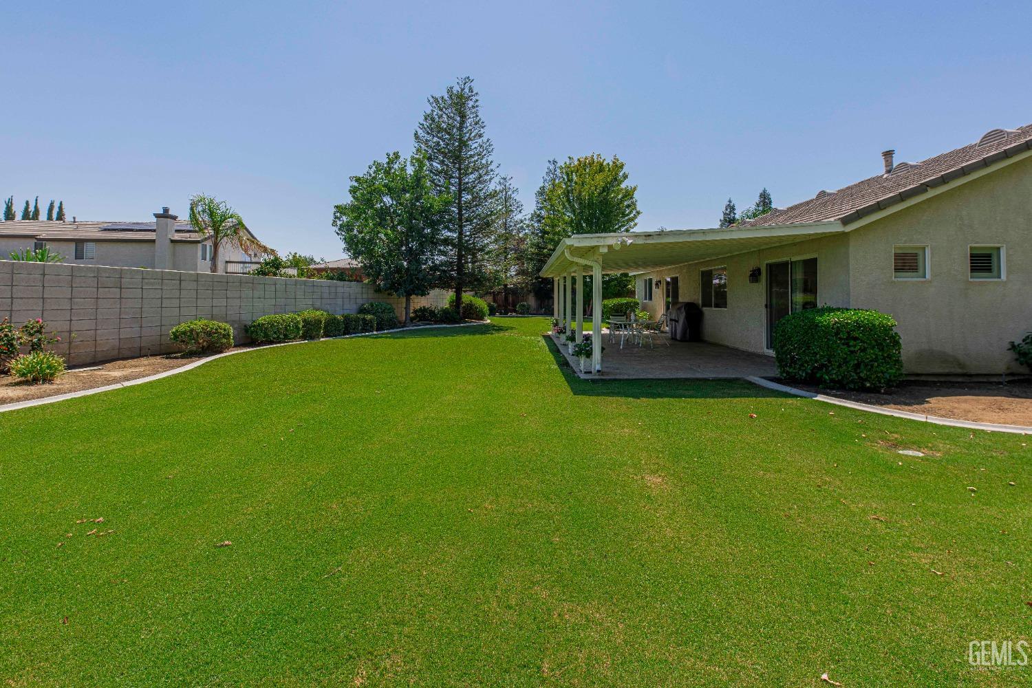 Undisclosed Address Bakersfield, CA 93312 - Photo 35 of 41 a view of a house with a backyard and a patio