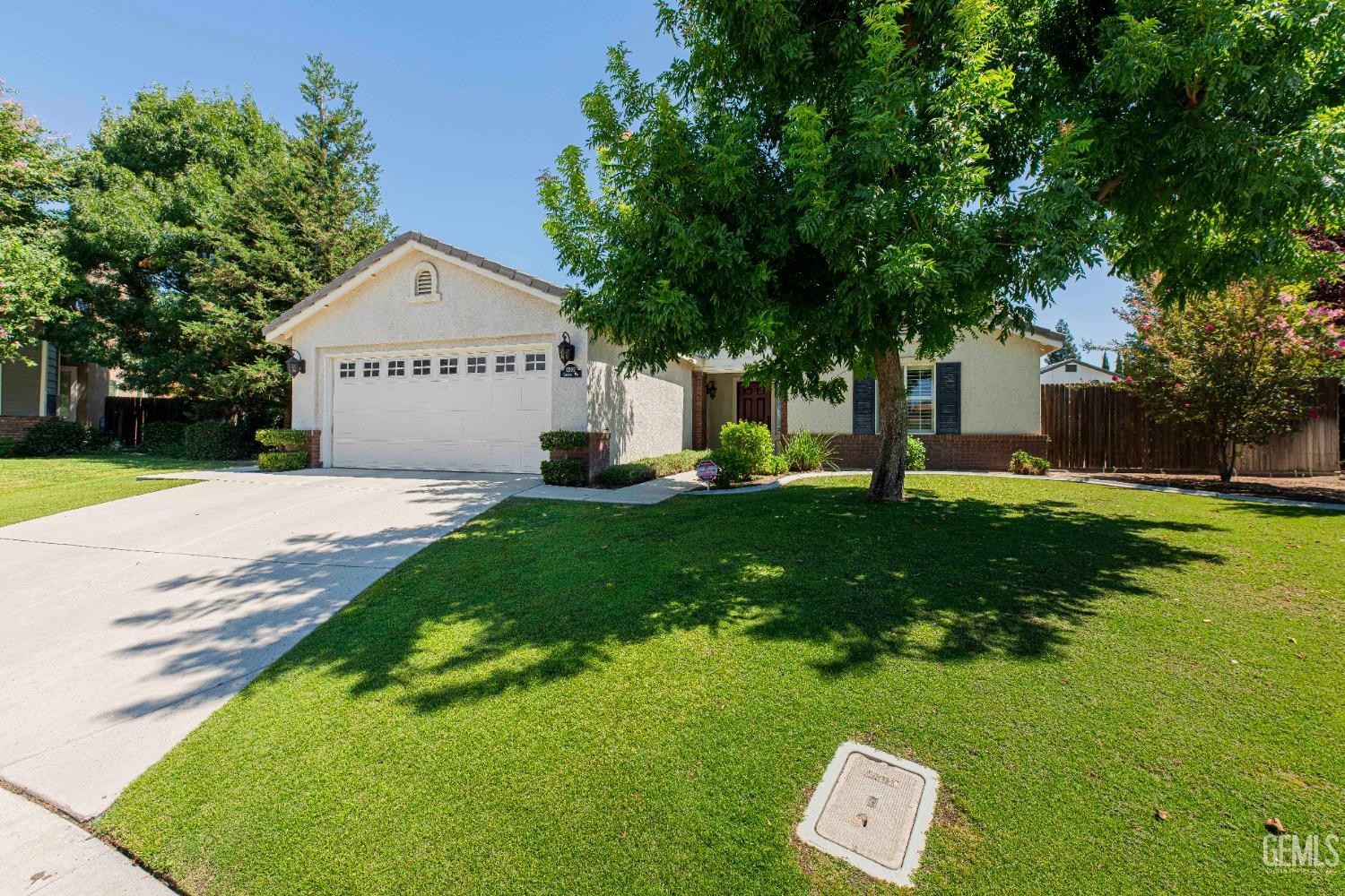 Undisclosed Address Bakersfield, CA 93312 - Photo 4 of 41 a front view of a house with a yard and trees