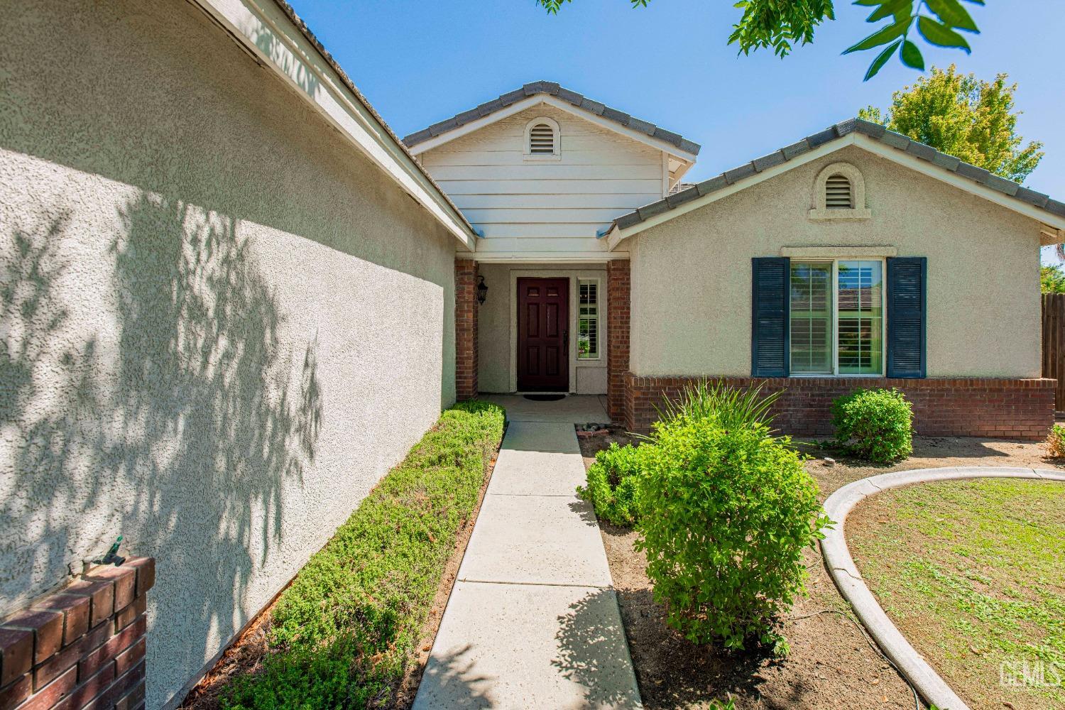 Undisclosed Address Bakersfield, CA 93312 - Photo 5 of 41 a front view of a house with garden
