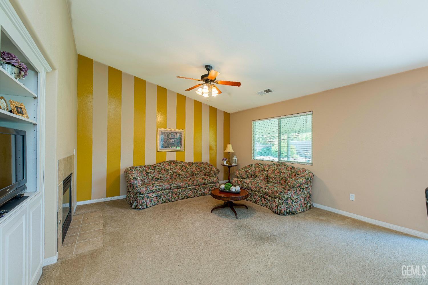 Undisclosed Address Bakersfield, CA 93312 - Photo 10 of 41 a living room with furniture and a flat screen tv