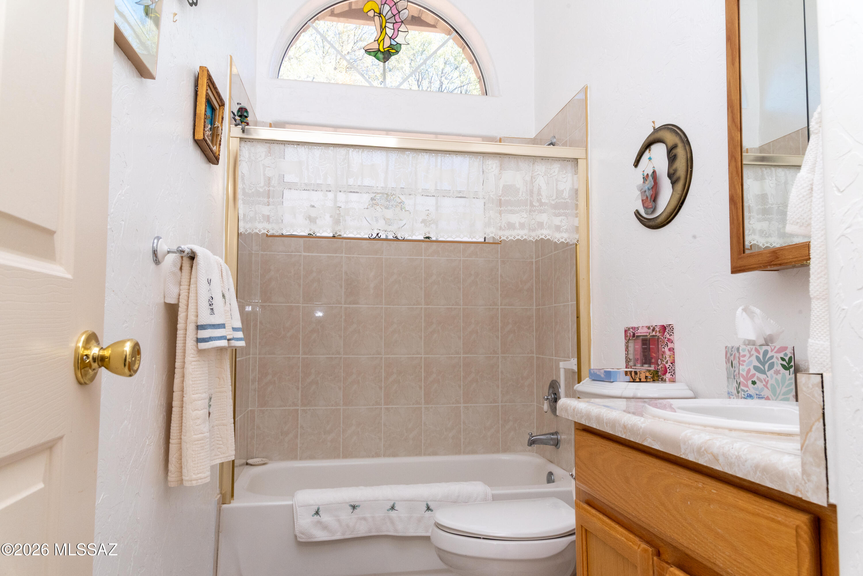 1242 Vista Court Rio Rico, AZ 85648 - Photo 8 of 16 a bathroom with a granite countertop sink a toilet and a shower