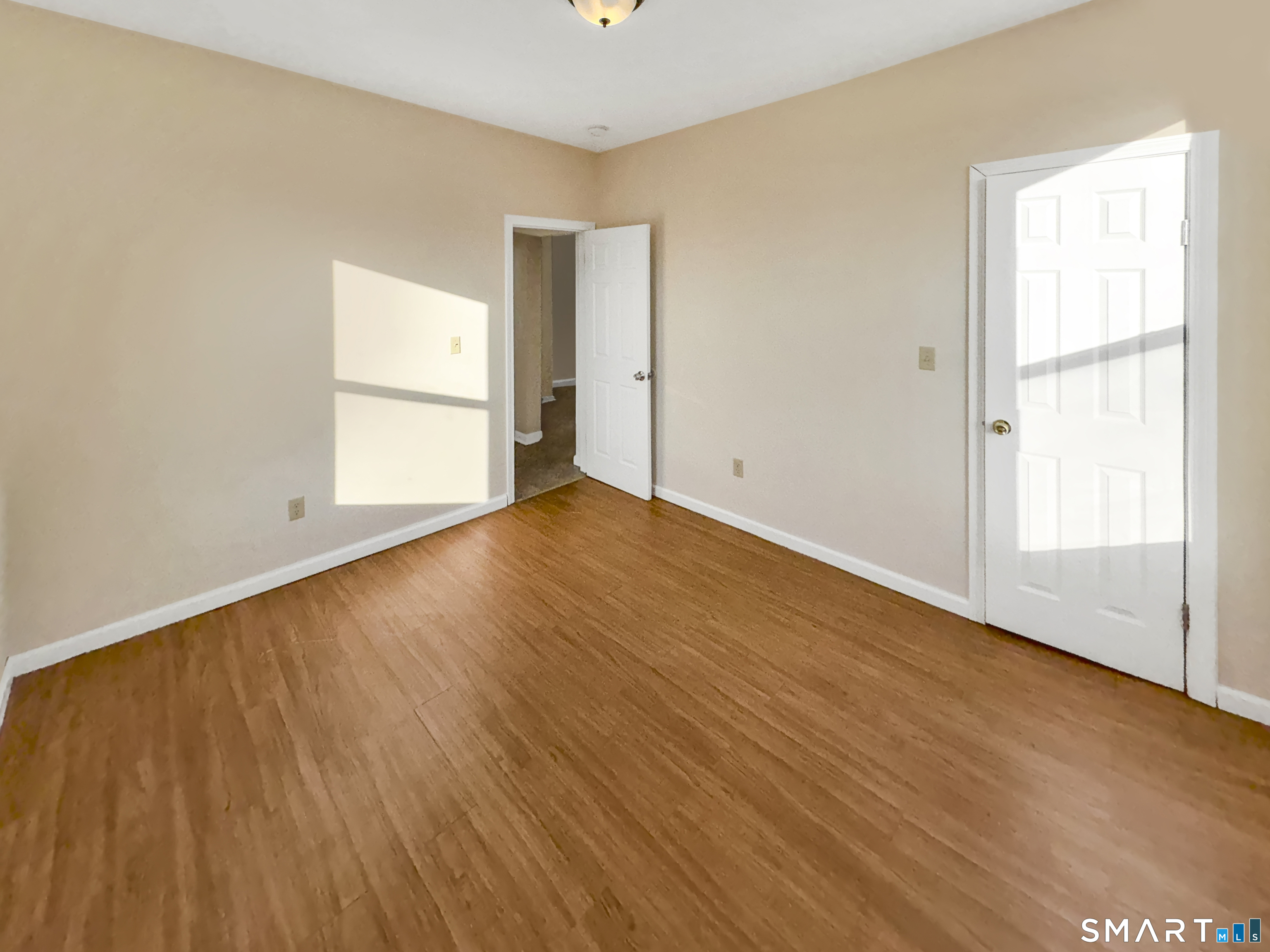 34 Wolcott Street, Unit 3 New Haven, CT 06513 - Photo 12 of 15 an empty room with wooden floor and windows
