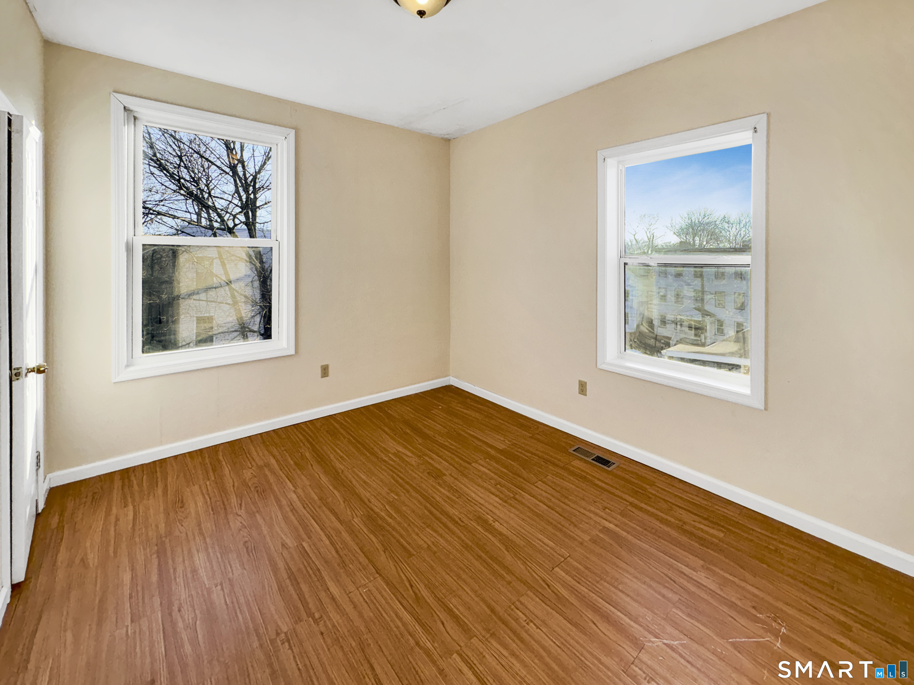 34 Wolcott Street, Unit 3 New Haven, CT 06513 - Photo 13 of 15 a view of an empty room with wooden floor and a window
