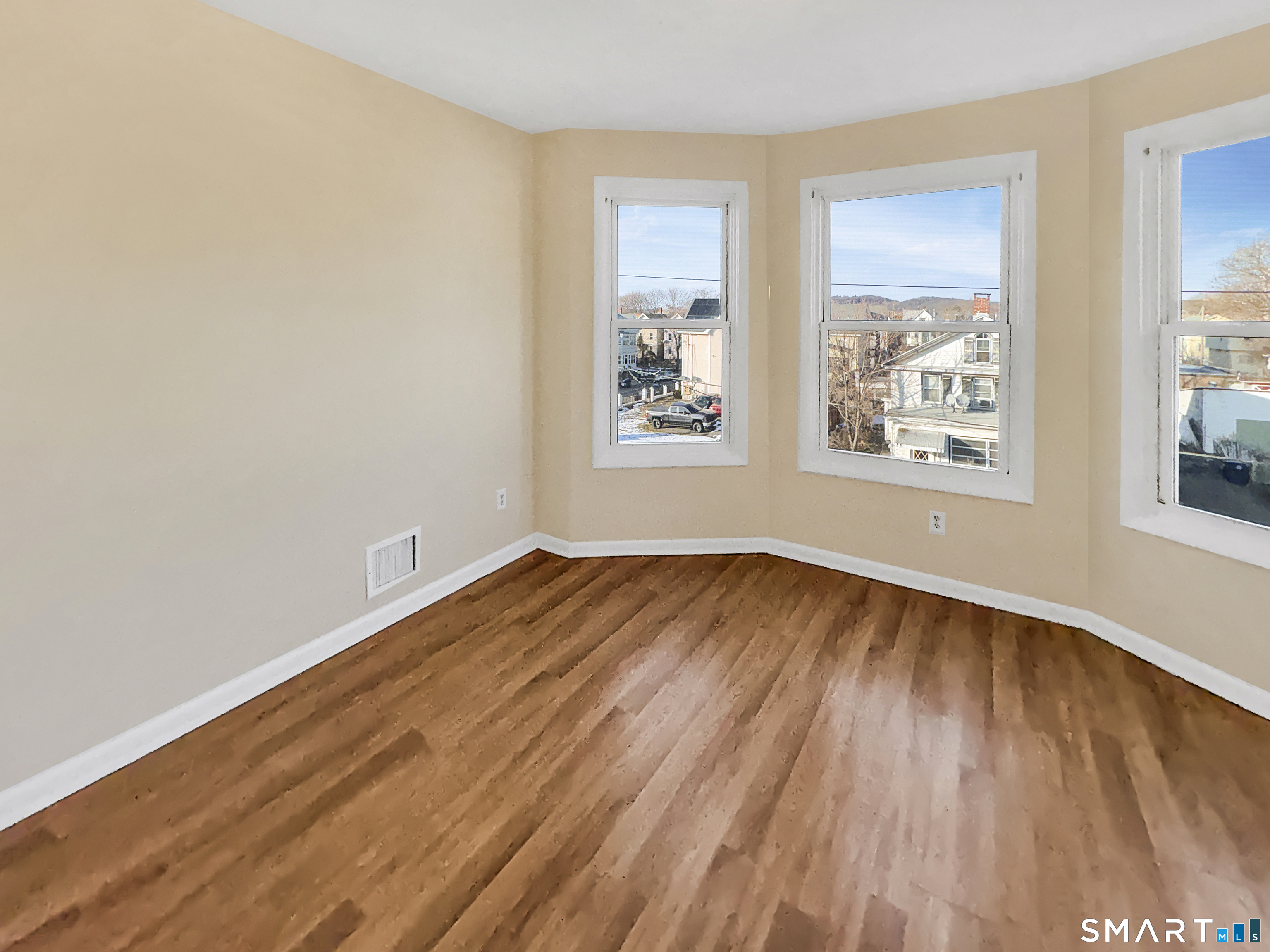 34 Wolcott Street, Unit 3 New Haven, CT 06513 - Photo 3 of 15 an empty room with wooden floor and windows