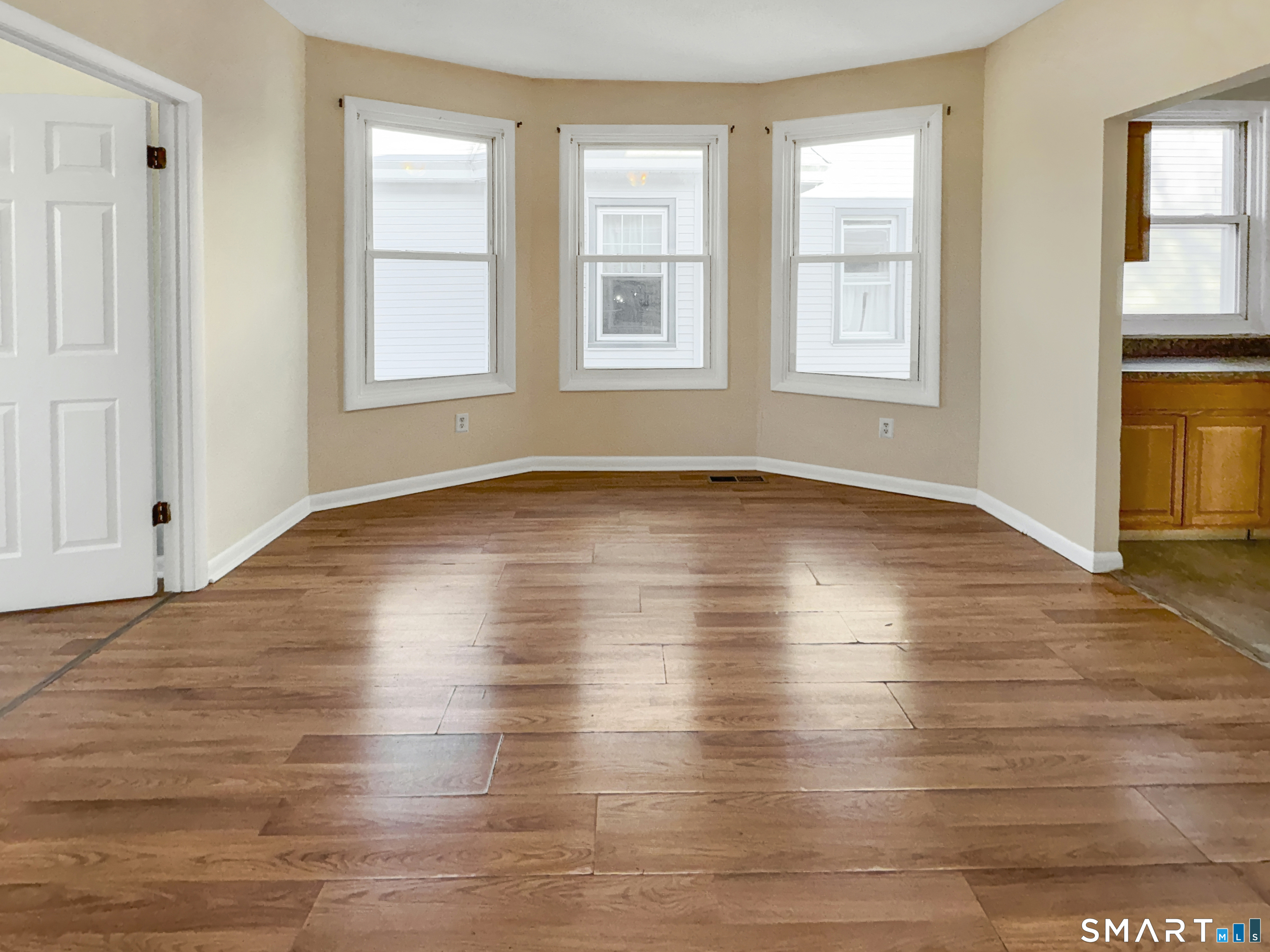 34 Wolcott Street, Unit 3 New Haven, CT 06513 - Photo 4 of 15 an empty room with wooden floor and windows