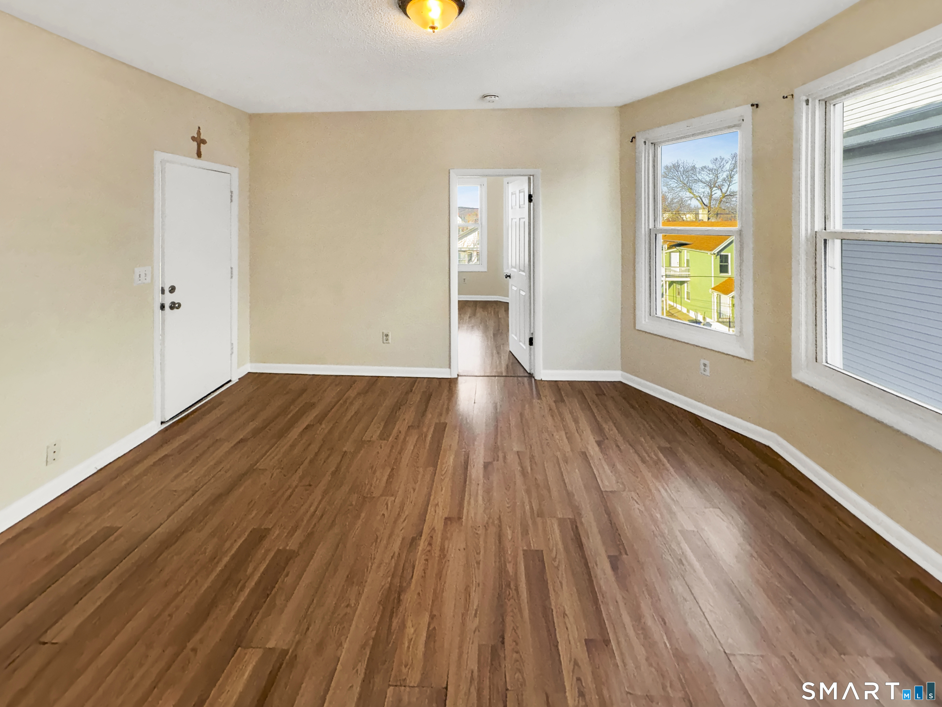 34 Wolcott Street, Unit 3 New Haven, CT 06513 - Photo 5 of 15 an empty room with wooden floor and windows