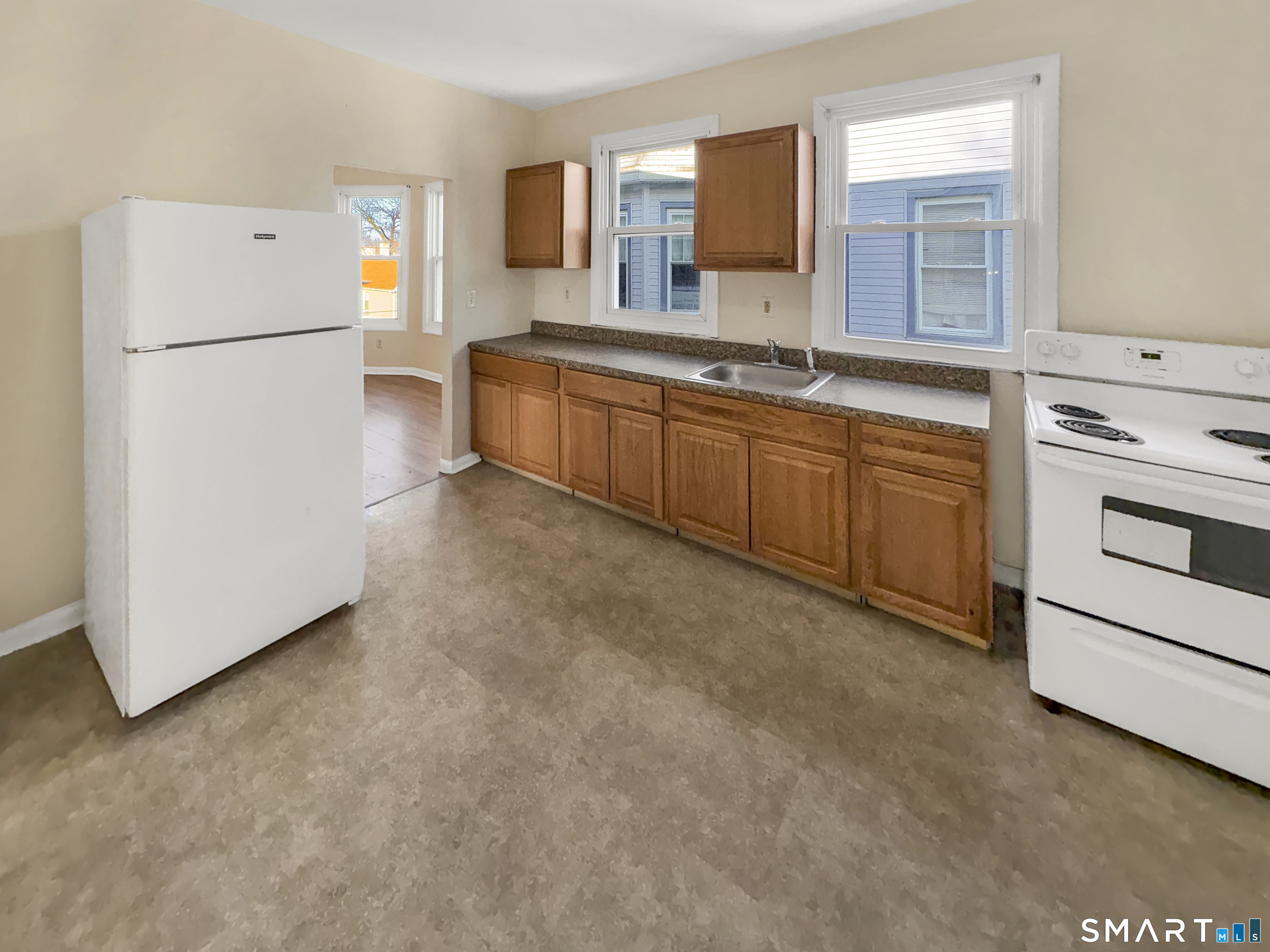 34 Wolcott Street, Unit 3 New Haven, CT 06513 - Photo 6 of 15 a kitchen with a refrigerator sink and white cabinets