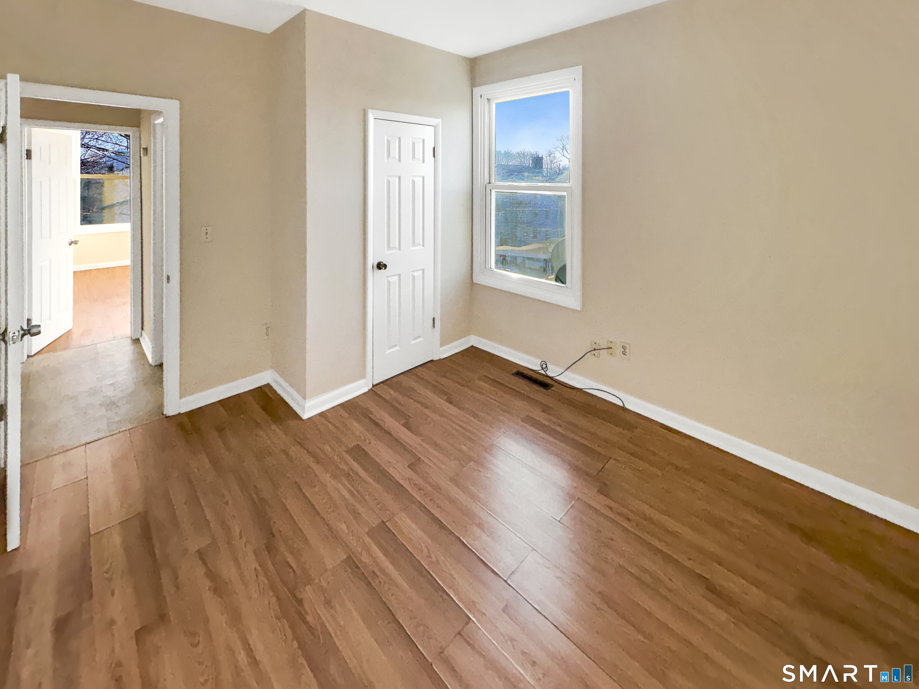 34 Wolcott Street, Unit 3 New Haven, CT 06513 - Photo 9 of 15 an empty room with wooden floor and windows