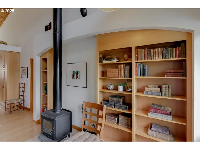 a living room with furniture and a book shelf