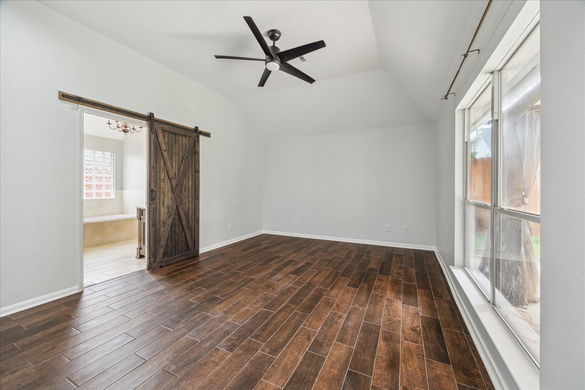 20910 Sandy Briar Court Spring, TX 77379 - Photo 19 of 28 Barn door for the primary on-suite bath