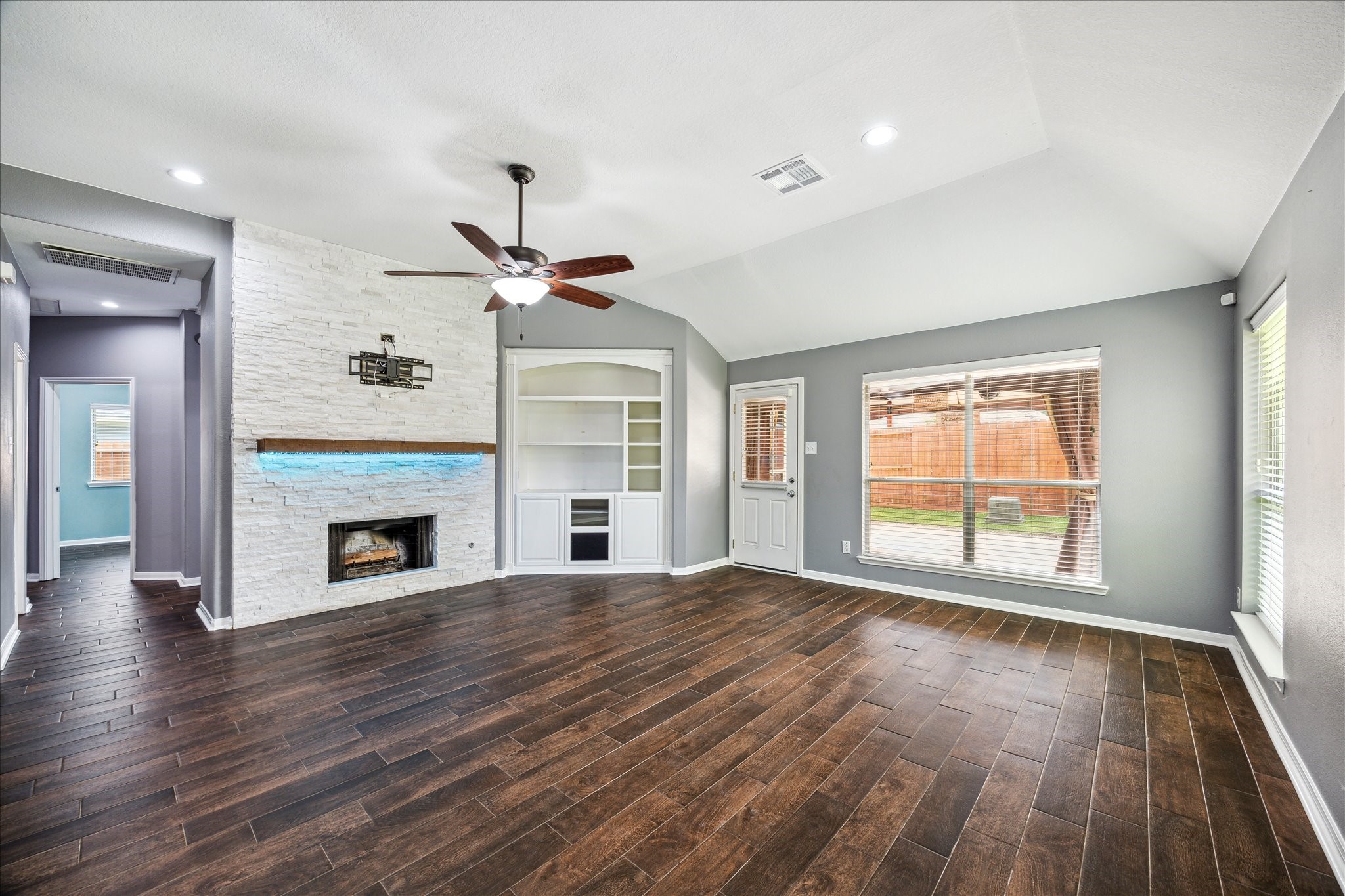 20910 Sandy Briar Court Spring, TX 77379 - Photo 10 of 28 Custom Built-Ins & Fireplace Accent the Living Space
