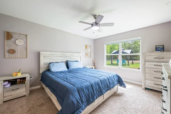 a bedroom with a large bed and a window