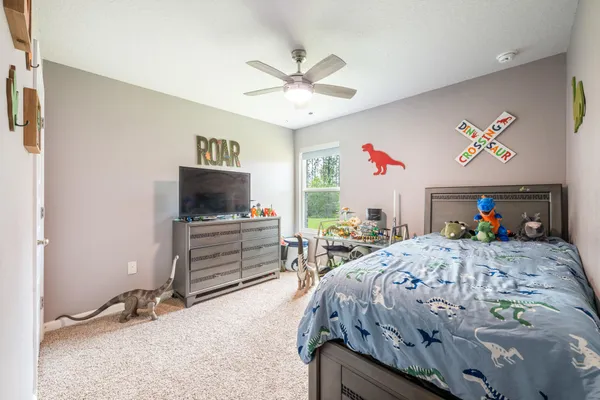 a bedroom with a bed and a dresser