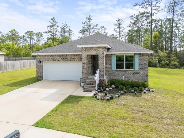 a front view of a house with a yard
