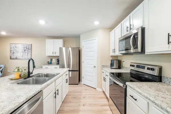 a kitchen with a refrigerator sink and microwave