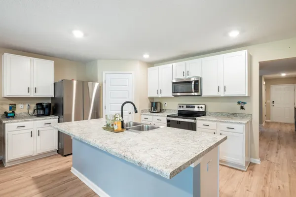 a kitchen with a stove and a microwave
