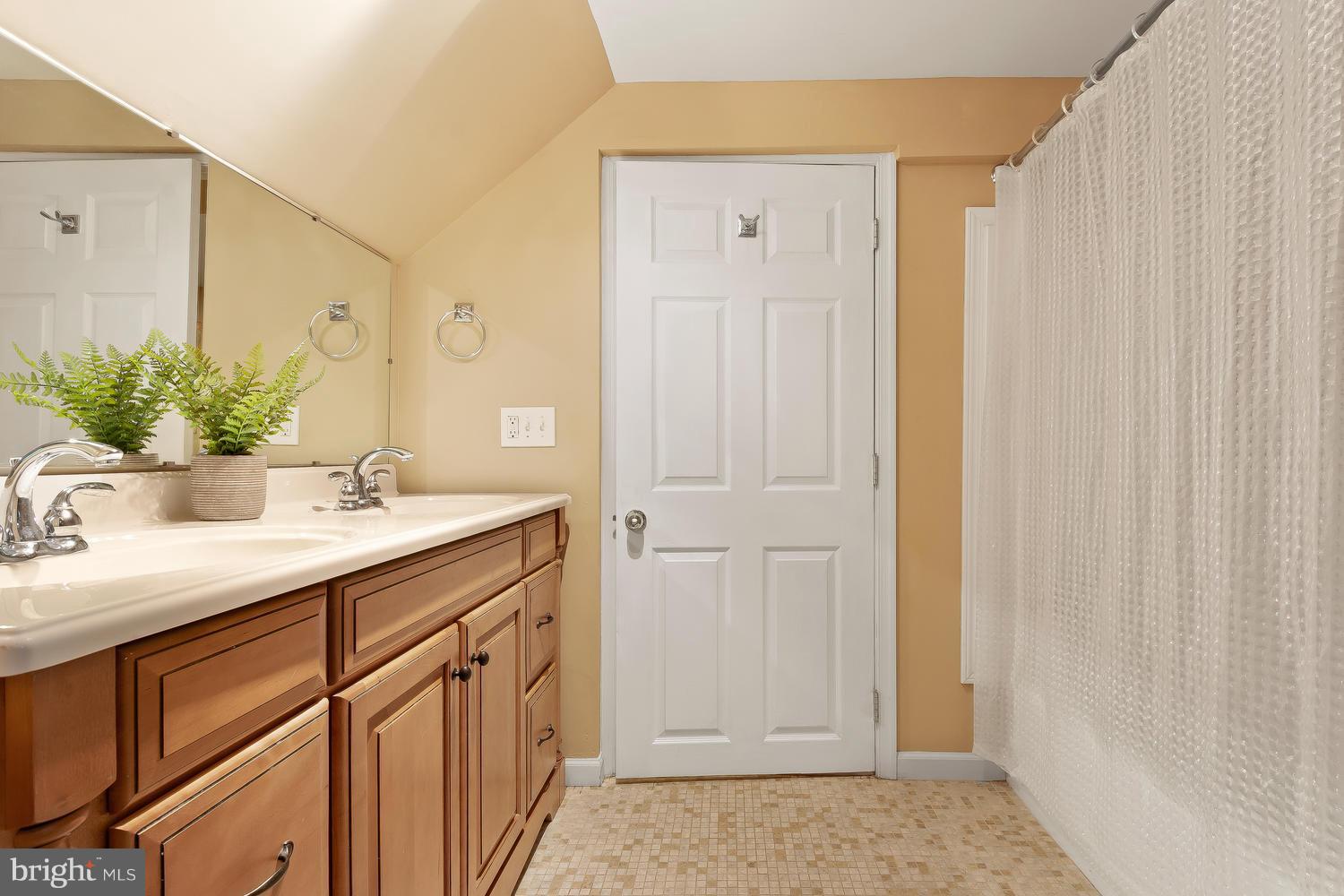 9505 St Andrews Way Silver Spring, MD 20901 - Photo 23 of 30 a bathroom with a sink and a mirror