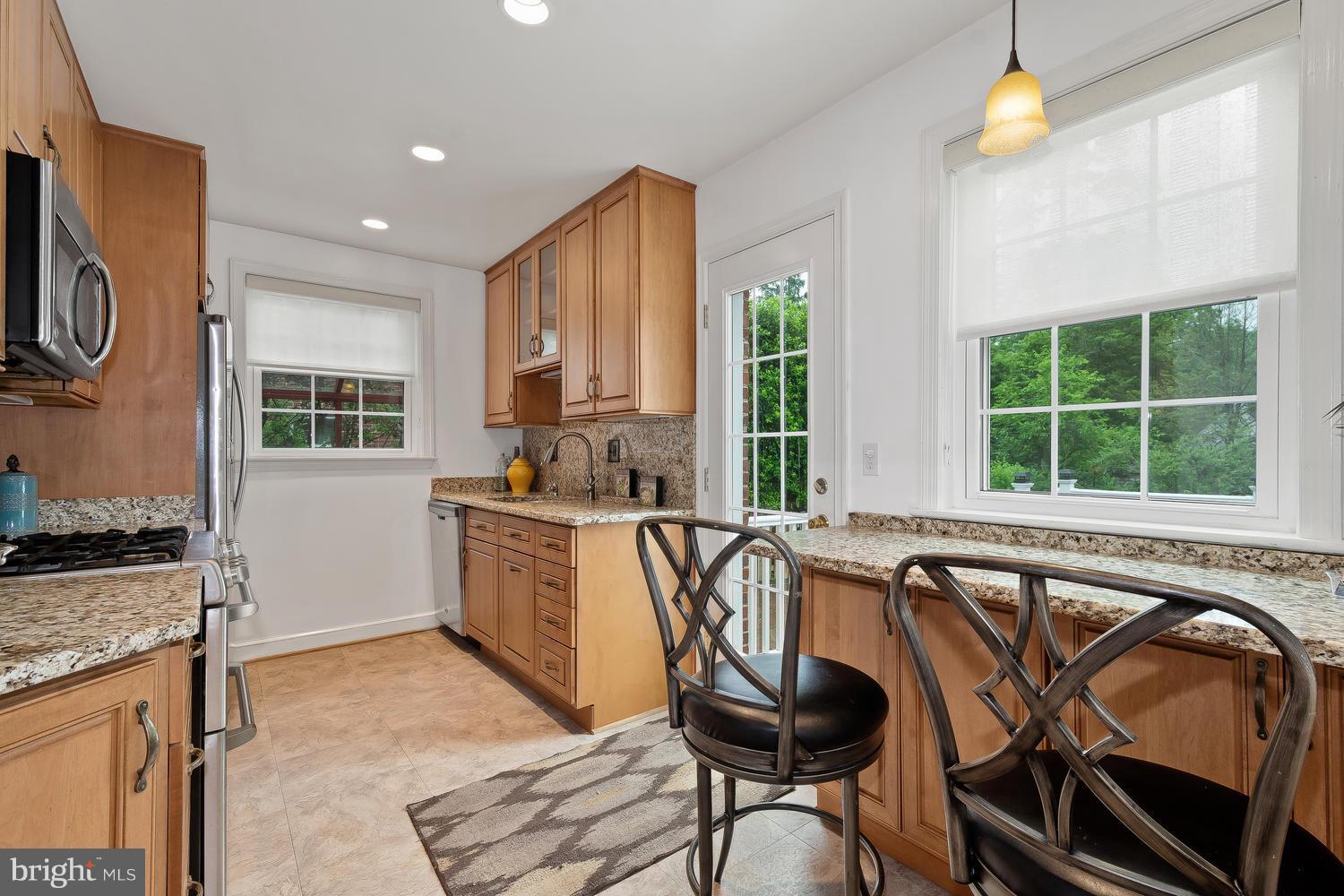 9505 St Andrews Way Silver Spring, MD 20901 - Photo 10 of 30 a view of a kitchen filled with furniture and windows