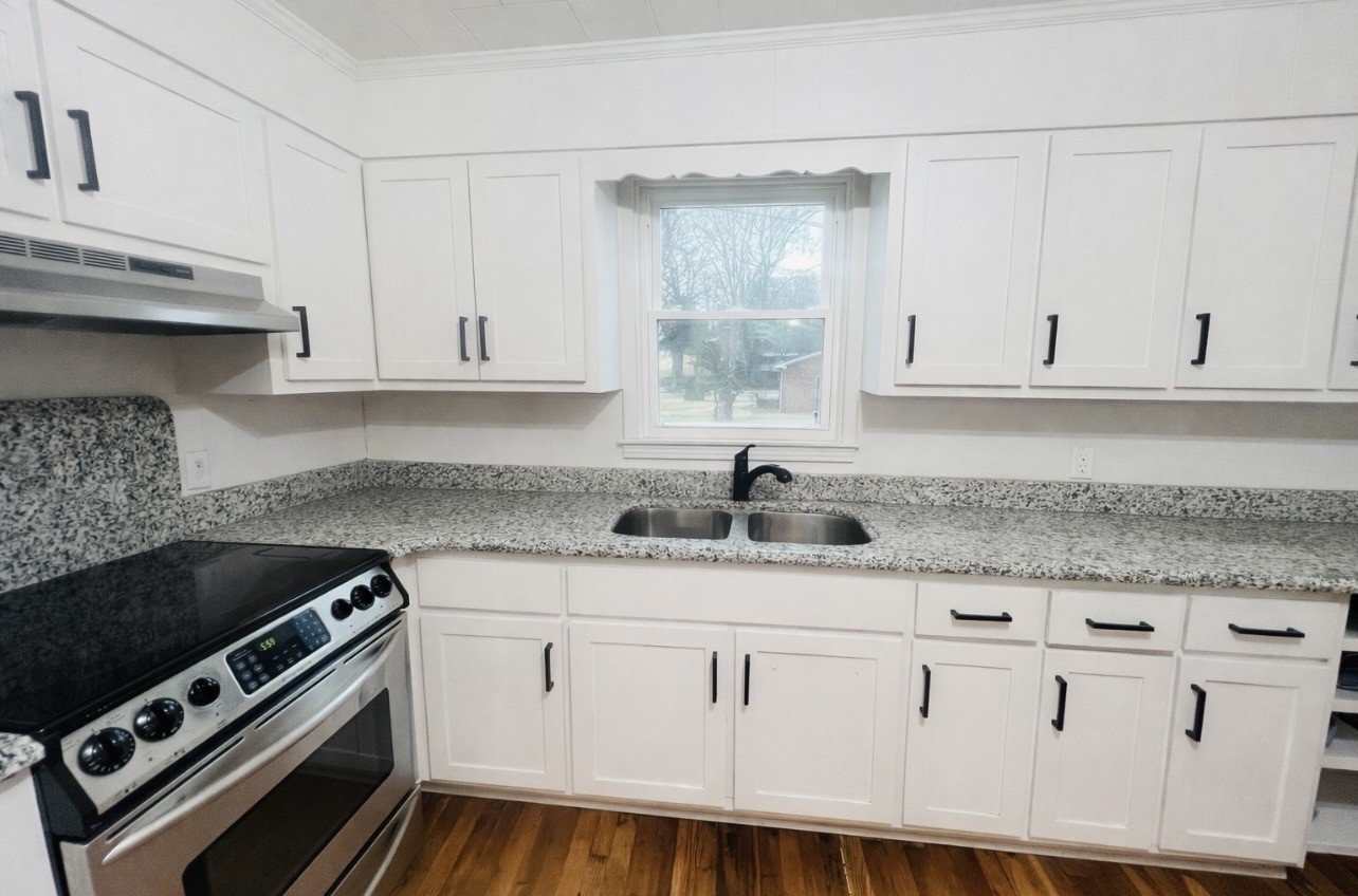299 West Shellsford Road McMinnville, TN 37110 - Photo 11 of 34 a kitchen with granite countertop a sink a stove and cabinets