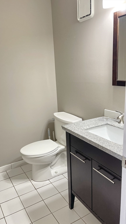 200 Market Street, Unit 505 Lowell, MA 01852 - Photo 13 of 22 a bathroom with a granite countertop toilet sink and mirror